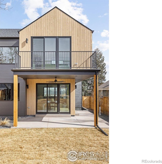 rear view of property featuring a patio area, a ceiling fan, a balcony, and fence