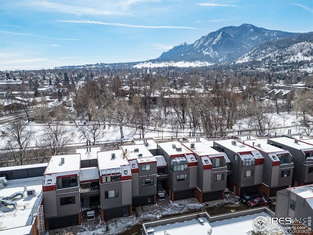 snowy aerial view featuring a mountain view