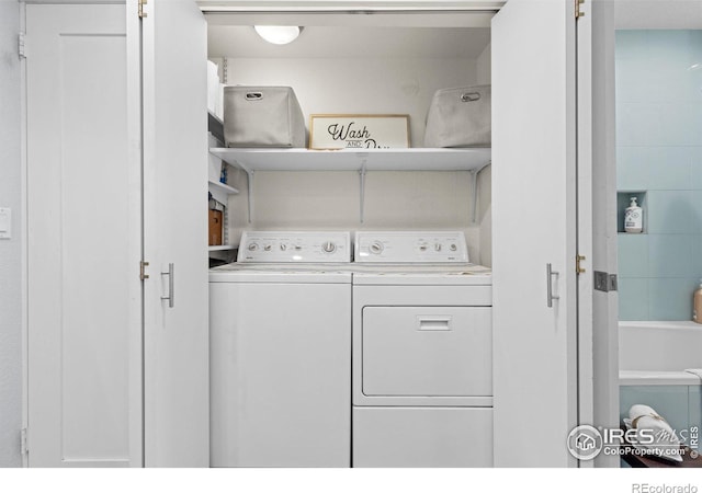 washroom featuring laundry area and washing machine and dryer