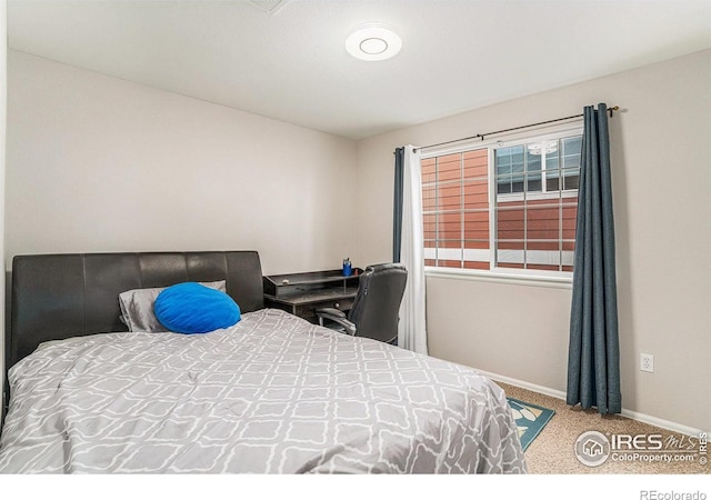 bedroom featuring baseboards and light colored carpet