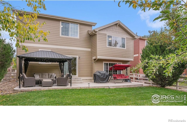 rear view of house featuring a patio, a gazebo, fence, a yard, and an outdoor living space