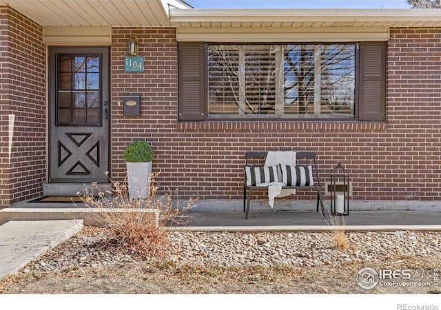 property entrance with brick siding