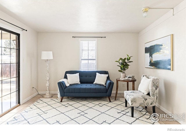 living area with light tile patterned floors and baseboards