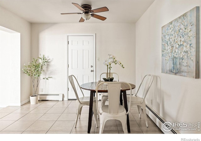 dining space with a baseboard heating unit, ceiling fan, baseboards, and light tile patterned floors