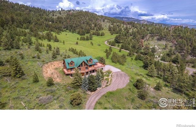 bird's eye view with a mountain view and a wooded view