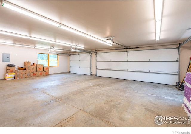 garage featuring a garage door opener and electric panel