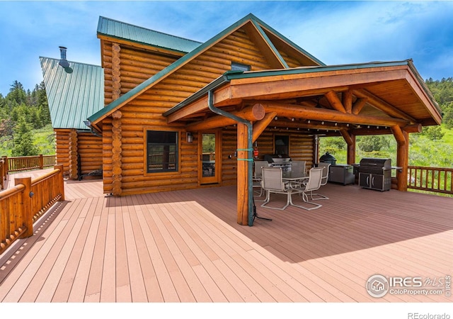 wooden deck with a grill and outdoor dining area