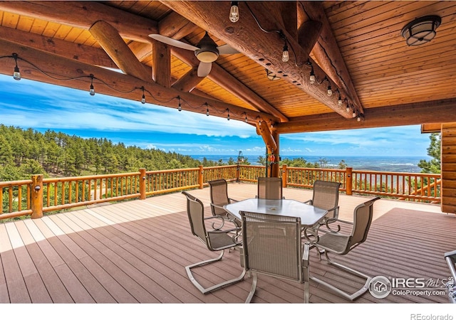 wooden terrace featuring outdoor dining space and a gazebo