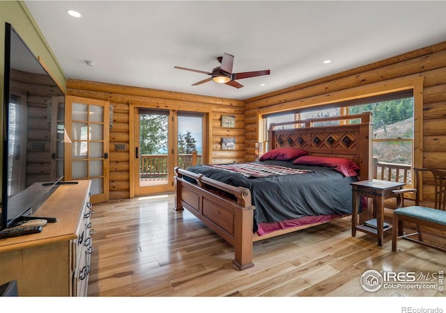 bedroom with access to outside, multiple windows, and recessed lighting