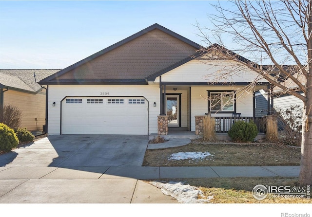 view of front of property with a garage, covered porch, and concrete driveway