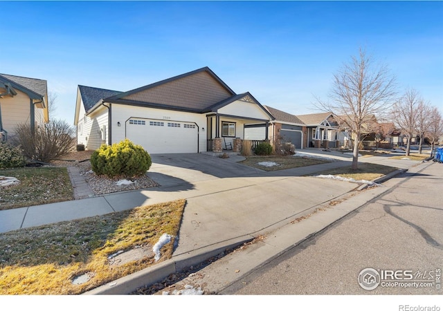 view of front of house with a garage, driveway, and a residential view