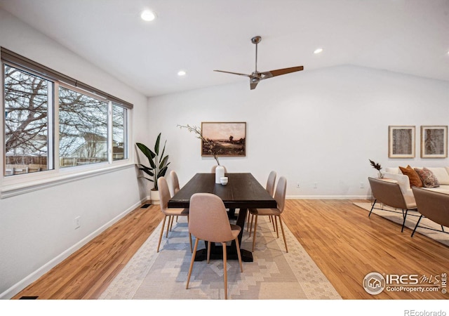 dining room with vaulted ceiling, light wood-style flooring, and recessed lighting