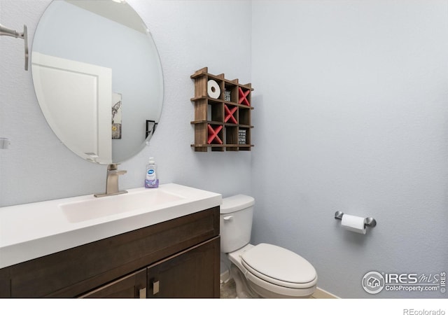 bathroom with toilet and vanity