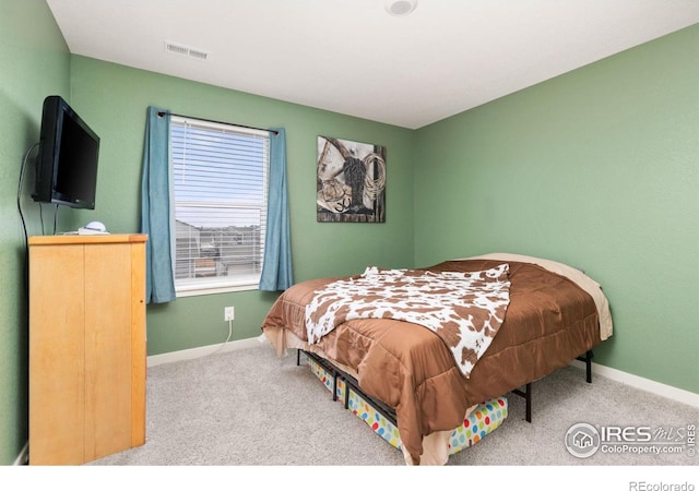 bedroom with carpet floors, visible vents, and baseboards