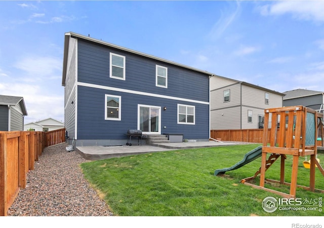 rear view of property featuring a fenced backyard, a lawn, a playground, and a patio