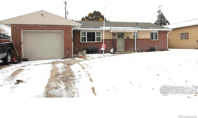 ranch-style house featuring a garage and brick siding