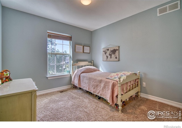 carpeted bedroom with visible vents and baseboards