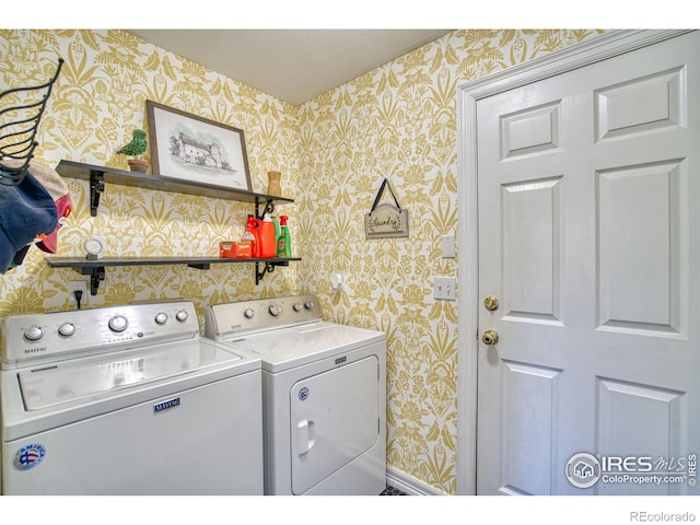 washroom with wallpapered walls, baseboards, laundry area, and washer and clothes dryer