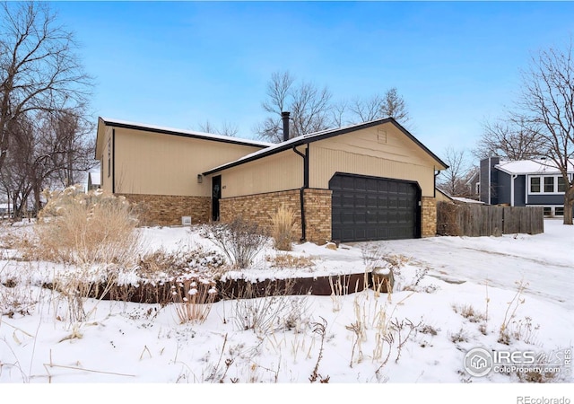 view of front of property with brick siding and an attached garage