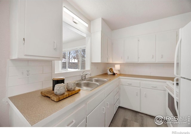 kitchen featuring light countertops and white cabinets