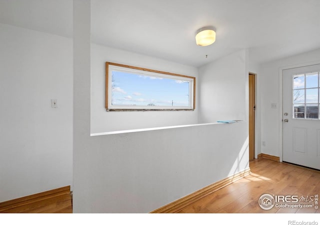 foyer with wood finished floors and baseboards