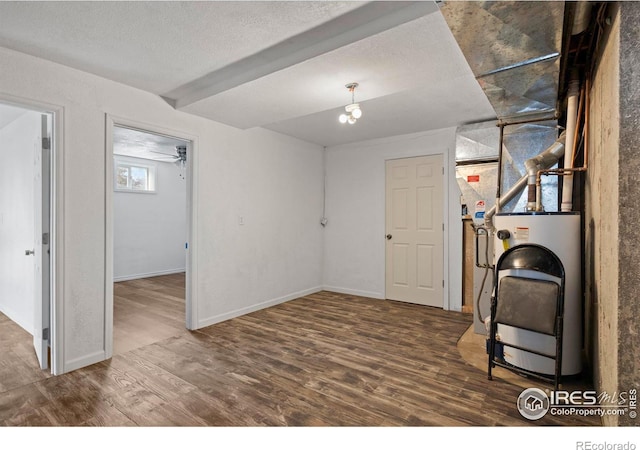 below grade area with washer / dryer, a textured ceiling, baseboards, and wood finished floors