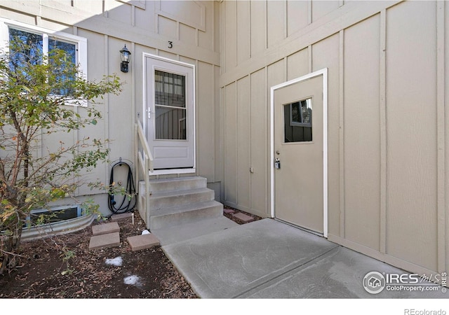 view of exterior entry with board and batten siding