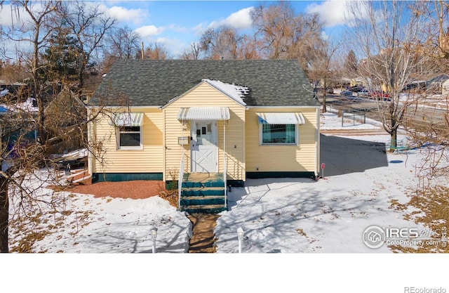 bungalow-style home with a shingled roof