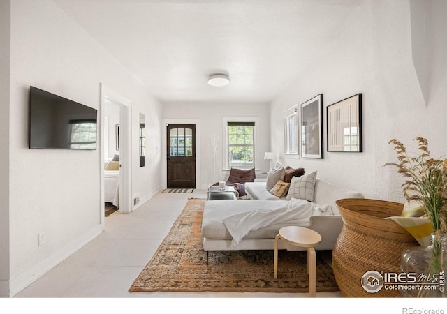 bedroom featuring light tile patterned floors and baseboards