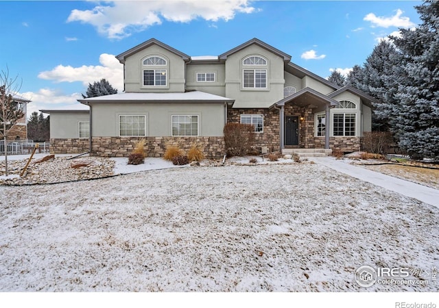 traditional home with stone siding and stucco siding