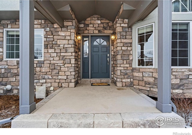 property entrance with stone siding