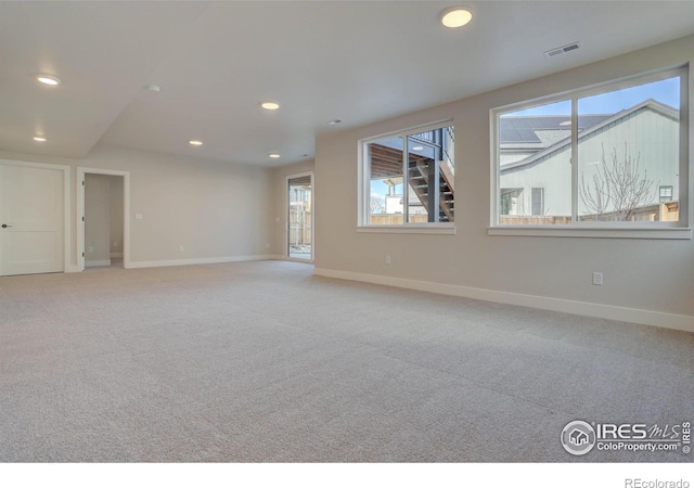empty room with baseboards, recessed lighting, visible vents, and light colored carpet