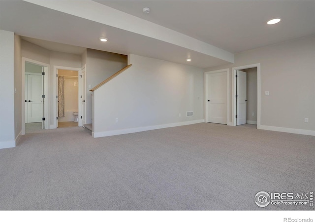 finished basement featuring baseboards, recessed lighting, and light colored carpet