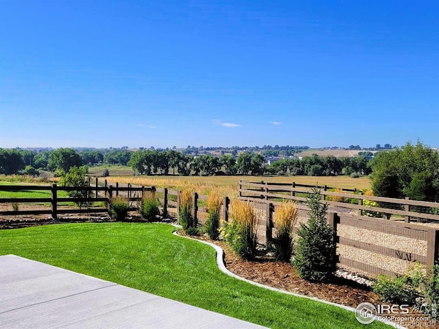 view of yard with a rural view and fence