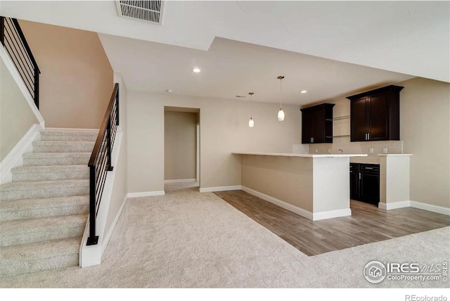 kitchen featuring visible vents, decorative light fixtures, light countertops, light wood-style floors, and recessed lighting