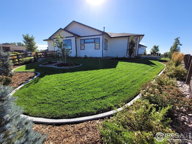 exterior space with a front yard and fence