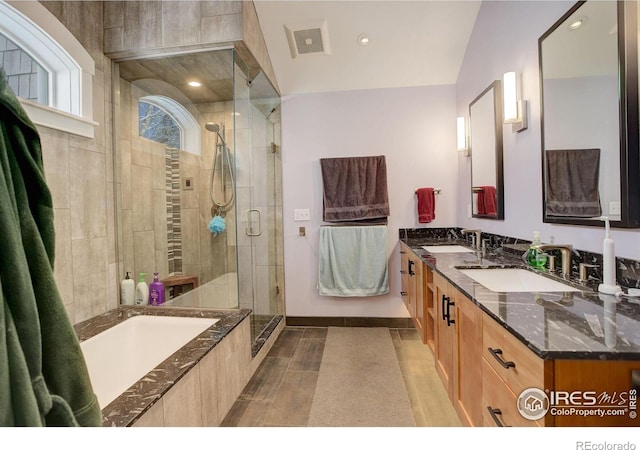 full bathroom featuring double vanity, a shower stall, visible vents, and a sink