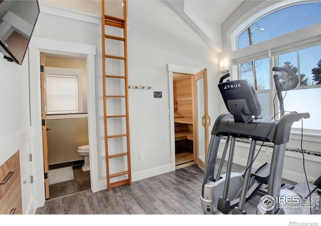 workout area with dark wood-style flooring and baseboards