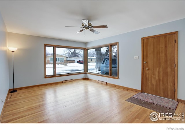 entrance foyer featuring light wood finished floors, ceiling fan, and baseboards