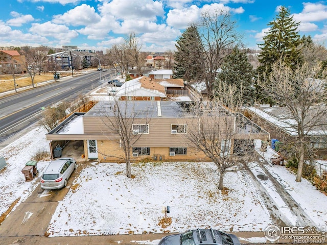 snowy aerial view with a residential view