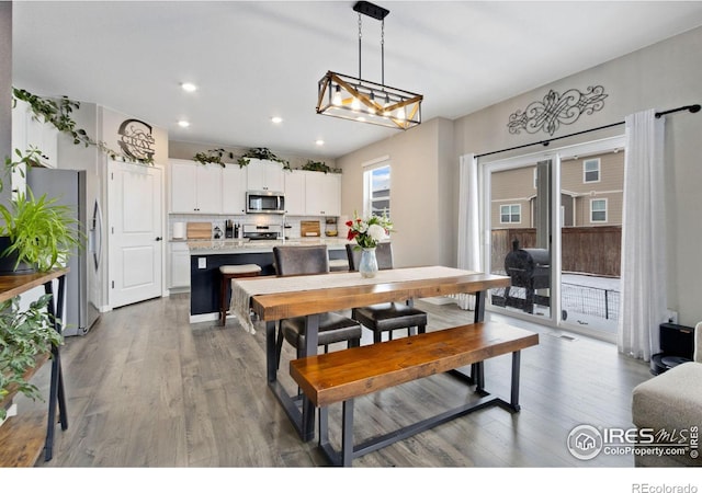 dining room with wood finished floors and recessed lighting