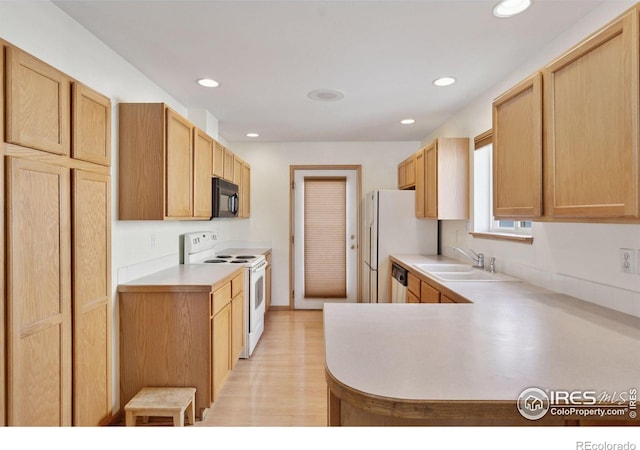 2143 Meadow Ct, Longmont, CO 80501 - kitchen with white appliances, a sink, light countertops, recessed lighting, and a peninsula
