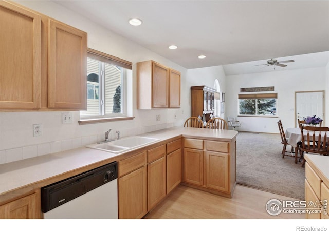 2143 Meadow Ct, Longmont, CO 80501 - kitchen with white dishwasher, a sink, open floor plan, a peninsula, and light countertops