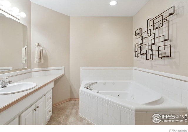2143 Meadow Ct, Longmont, CO 80501 - bathroom with a jetted tub, vanity, tile patterned floors, recessed lighting, and baseboards