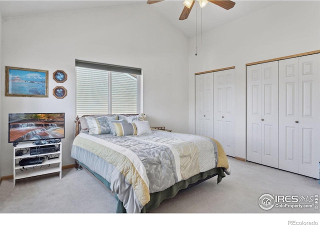 2143 Meadow Ct, Longmont, CO 80501 - carpeted bedroom featuring two closets, high vaulted ceiling, ceiling fan, and baseboards