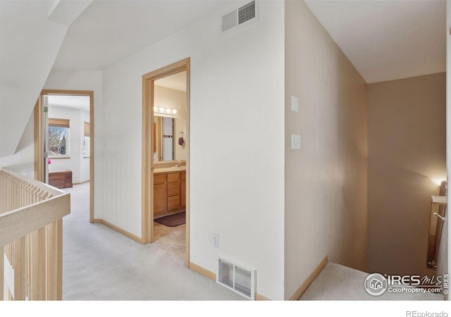 2143 Meadow Ct, Longmont, CO 80501 - corridor featuring light carpet, baseboards, and a sink