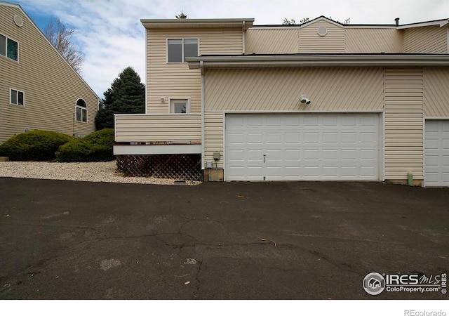 2143 Meadow Ct, Longmont, CO 80501 - garage with asphalt driveway