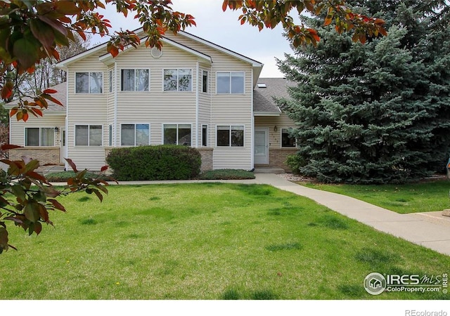 2143 Meadow Ct, Longmont, CO 80501 - view of front facade featuring a front lawn and brick siding