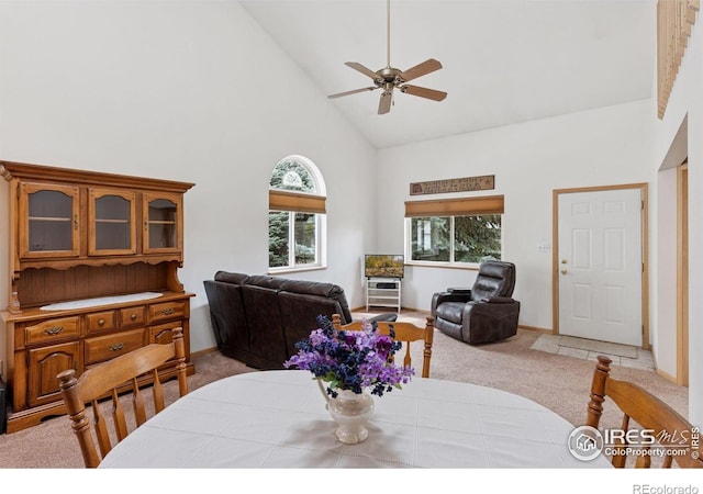 2143 Meadow Ct, Longmont, CO 80501 - dining room with high vaulted ceiling, light colored carpet, a ceiling fan, and baseboards
