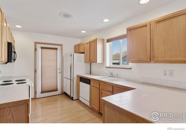 2143 Meadow Ct, Longmont, CO 80501 - kitchen featuring white appliances, a sink, light wood-style floors, light countertops, and recessed lighting